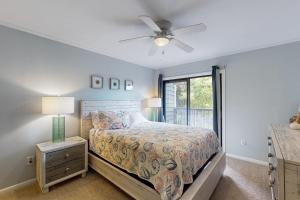 a bedroom with a bed and a ceiling fan at Island Beach & Racquet Club H115 in Atlantic Beach