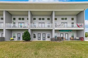 a large white building with a yard in front of it at Completely Coastal Spacious townhome with Harbor views a Dock and community Pool in Fort Walton Beach