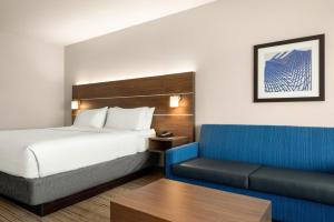 a hotel room with a bed and a couch at Holiday Inn Express & Suites - West Des Moines - Jordan Creek by IHG in West Des Moines +27 photos