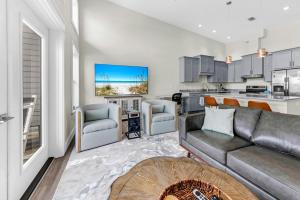 a living room with a couch and a kitchen at Completely Coastal Spacious townhome with Harbor views a Dock and community Pool in Fort Walton Beach