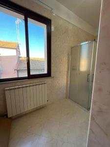 a large bathroom with a shower and a window at Il Sogno in Senigallia