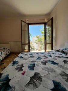 a bedroom with a large bed with a large window at Il Sogno in Senigallia
