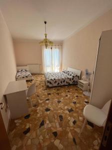 a room with two beds and a tile floor at Il Sogno in Senigallia