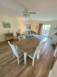 a living room with a wooden table and chairs at Lighthouse Point Rental 8B in Tybee Island
