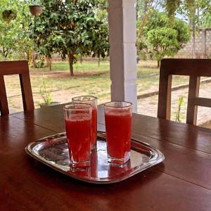 two glasses sitting on a tray on a table at Nesan’s villa in Trincomalee