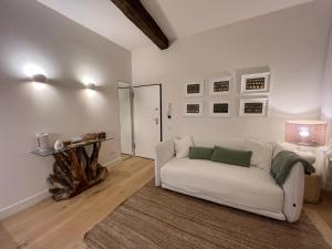 a living room with a white couch and a mirror at Camogli - "Il Nido" - Liguria Holidays in Camogli +14 photos