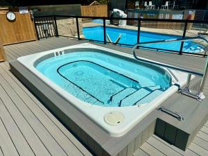 a jacuzzi tub on the deck of a boat at Mountain Side Studio at The Blue Mountains in Blue Mountains