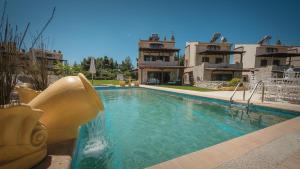 a swimming pool with a water slide in front of a house at Zeus Sea View Villa with Private Pool, Afytos in Afitos +83 photos