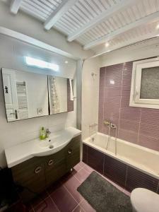 a bathroom with a tub and a sink and a bath tub at Beautiful apartment in Mykonos town ! in Mýkonos City