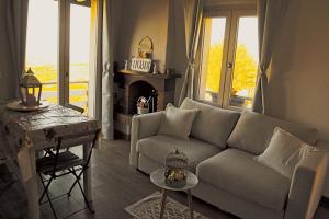 a living room with a couch and a table at NiFe Tiny House - Secret Garden in Montalbo