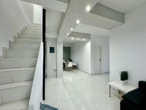 a white hallway with stairs and a dining room at Four Seasons - The White Queen House in Kriopigi +47 photos