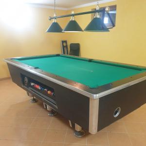a pool table in a room with a green pool at Domek w Górach in Lubawka +6 photos