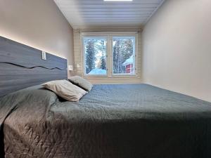 En eller flere senge i et værelse på Villa Kiviaapa in Ruka Kuusamo