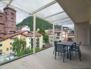 a balcony with a table and chairs and a view at SWEETHOME MUSEO - con Garage in Bolzano