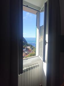 a window with a view of a city at Appartamento Giovanna in Riomaggiore