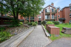 a brick walkway in front of a building at Le Bordeau à Saint-Sauveur in Saint-Sauveur-des-Monts