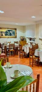 a dining room with tables and chairs and tablesktop at Hotel La Rivera in Arenas de Cabrales