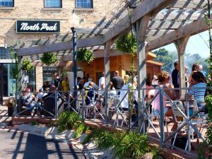 a group of people sitting outside of a restaurant at Downtown Newly Remodeled Apartment AC Beach Restaurants Breweries Nightlife in Traverse City