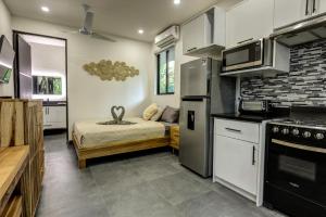 a small kitchen with a bed in a room at Villa Colibri - Private 1 bedroom Studio/Bachelor in Punta Uva