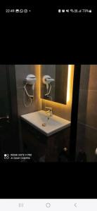 a bathroom with a white sink and a mirror at Başar hotel in Erdemli