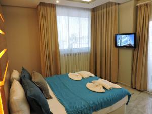 a bedroom with a bed with two towels on it at Başar hotel in Erdemli