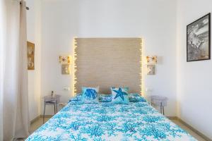 a bedroom with a blue bed with blue pillows at Fortino B&B Capri in Capri