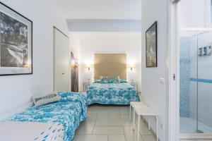 a small room with two beds and a window at Fortino B&B Capri in Capri