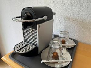 a coffee maker on a table with plates and glasses at Ferienwohnung an der Traun in Bad Aussee