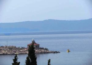 a lighthouse on an island in the middle of the water at Villa Melassy in Makarska