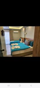 a bedroom with a large bed with blue sheets at Başar hotel in Erdemli