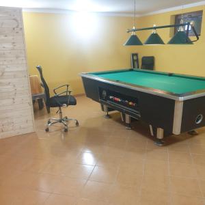 a room with a pool table and two chairs at Domek w górach 2 in Lubawka
