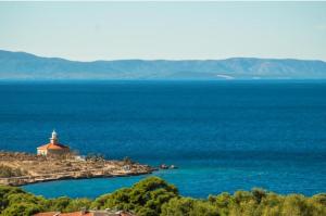 a lighthouse on an island in the middle of the ocean at Villa Melassy in Makarska