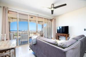 a living room with a couch and a television at Vista Del Arco in Cabo San Lucas