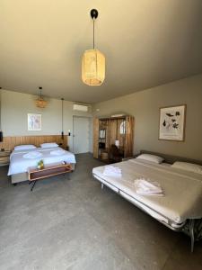 a bedroom with two beds and a chandelier at Petrichor in Kalamata