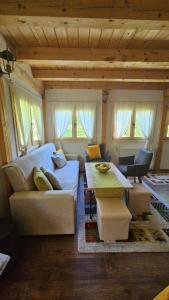 a living room with a couch and a table at Vacation Home Gaj in Visoko