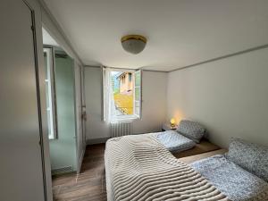 a bedroom with a large bed and a window at 2 Rooms with kitchen by Interlaken in Därligen