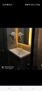 a bathroom with a white sink and a mirror at Başar hotel in Erdemli