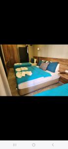 three beds in a room with blue pillows at Başar hotel in Erdemli