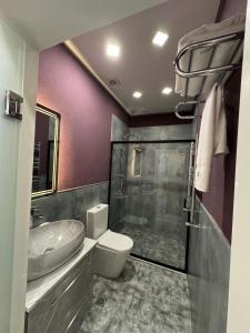 a bathroom with a sink and a toilet and a shower at Liberta Hotel Baku in Baku