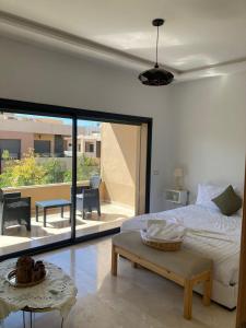 New villa in Marrakech palmeraie في مراكش: غرفة نوم بسرير ومنظر على فناء