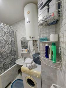 a small bathroom with a toilet and a sink at Stan na dan Alexa sa free parkingom in Novi Sad +17 photos