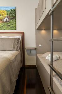 a small bedroom with a bed and a staircase at Hospedagem Tri-Best in Pomerode