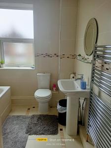 a bathroom with a toilet and a sink at Goldy's place in E17 Room2 in London