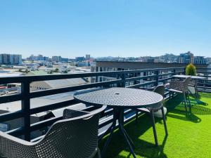 a patio with a table and chairs on a balcony at DEE-LOFT 53 in Windhoek