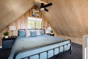 a bedroom with a bed with a ceiling fan at Chalet w Stunning Views Hot Tub Fire Pit & WiFi in Old Fields