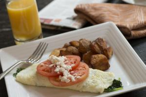 a plate of food with eggs and tomatoes and potatoes at Lancaster Marriott at Penn Square in Lancaster