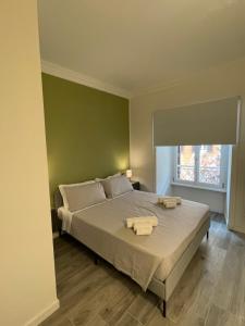 a bedroom with a bed with two towels on it at This must be the place Rome Guesthouse in Rome