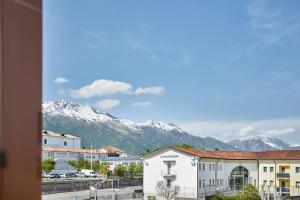 a view of a city with mountains in the background at Lux Apartment Aviano Centro AC Parking in Aviano