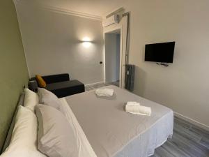 a bedroom with a bed with two towels on it at This must be the place Rome Guesthouse in Rome