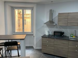 a kitchen with a sink and a table with a microwave at This must be the place Rome Guesthouse in Rome +20 photos